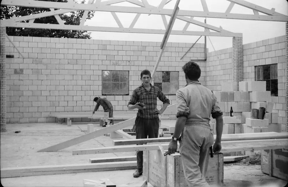 Zwart-witfoto van mannen aan het werk bij de bouw van de garage